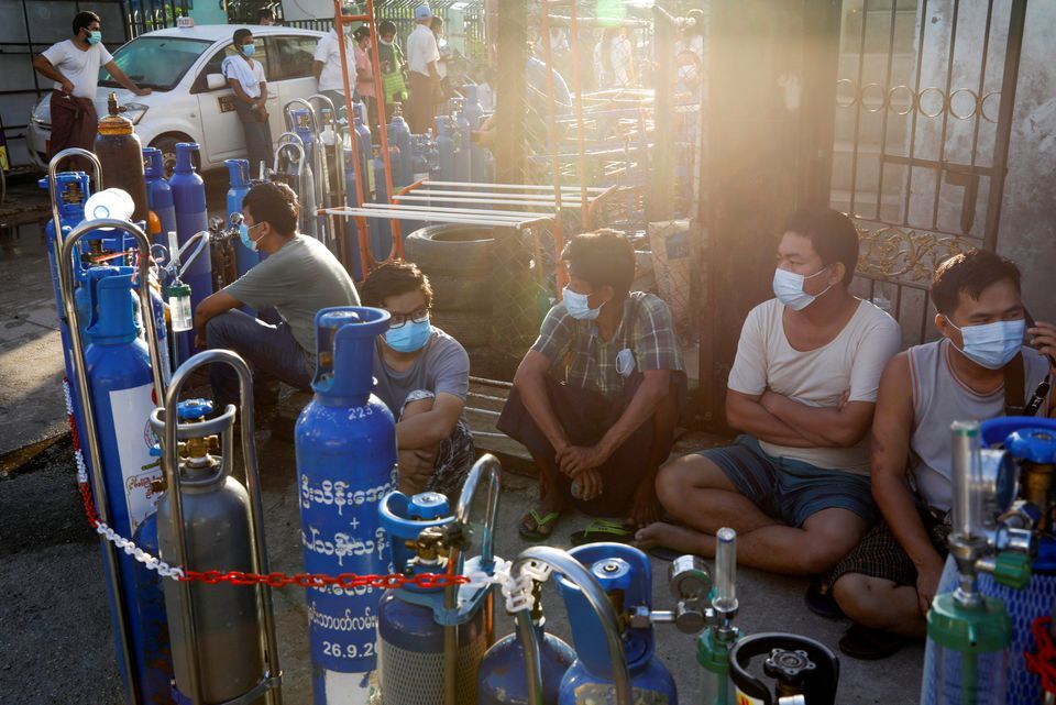 Locals line up with their tanks to refill oxygen during the coronavirus outbreak in Yangon, Myanmar, July 14. &mdash; Reuters