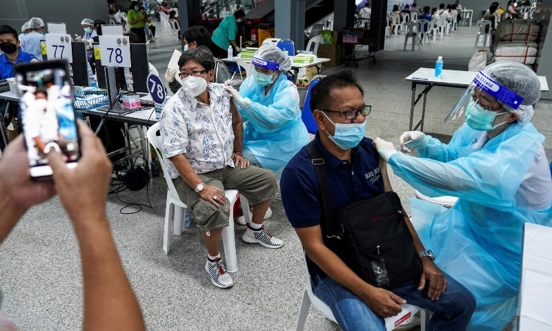 People receive the first dose of the AstraZeneca Covid-19 vaccine at the Central Vaccination Centre, inside the Bang Sue Grand Station on June 21. &mdash; Reuters