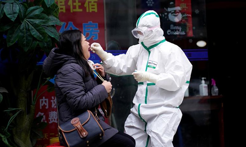 A woman receives a nucleic acid test for Covid-19 in Wuhan, China. &mdash; Reuters/File