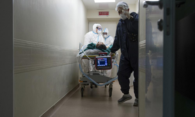 Medics wearing special suits to protect against coronavirus transport a patient with coronavirus at the City hospital No. 52 for coronavirus patients in Moscow, Russia. — AP