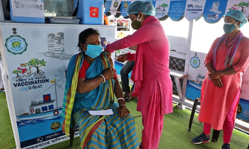 Angurbala Kamila, 45, a villager, receives a dose of the Covishield vaccine, a vaccine manufactured by the Serum Institute of India, on a boat during the Vaccination on Boat programme in Gosaba Island in the eastern state of West Bengal, India. — Reuters/File