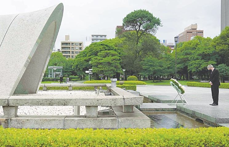 HIROSHIMA: International Olympic Committee president Thomas Bach offers flowers to Hiroshima Memorial Cenotaph during his visit on Friday.—AP HIROSHIMA: International Olympic Committee president Thomas Bach offers flowers to Hiroshima Memorial Cenotaph during his visit on Friday.—AP
