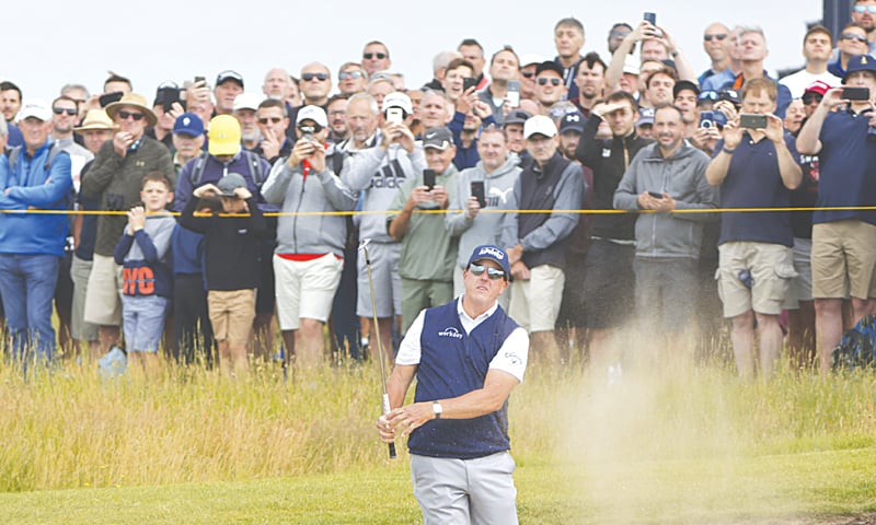 SANDWICH: Phil Mickelson of the US plays out of a bunker on the first hole during the second round of the British Open at Royal St George&rsquo;s on Friday.&mdash;AP