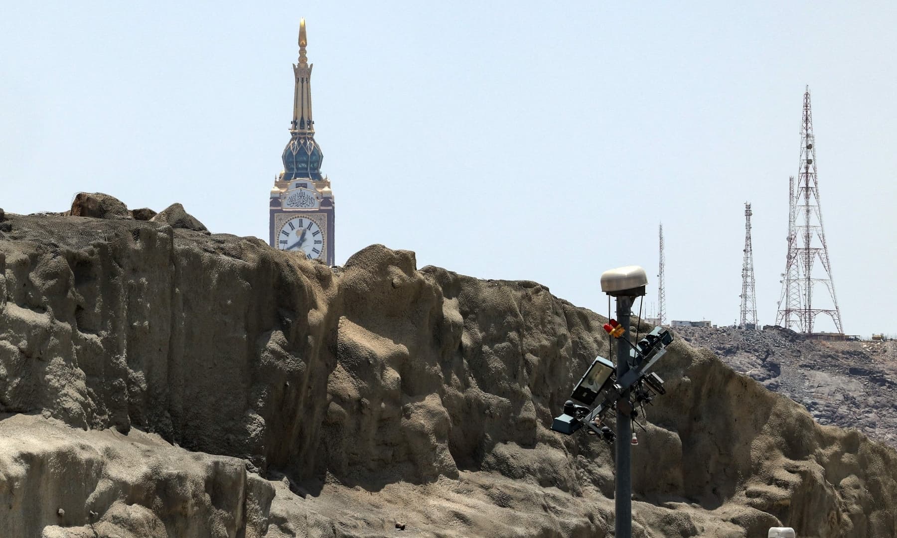 This picture shows a partial view of Mount Arafat, the tip of the Makkah Royal Clock Tower, and security cameras, southeast of the holy city of Makkah, Saudi Arabia, July 16, 2021. — AFP