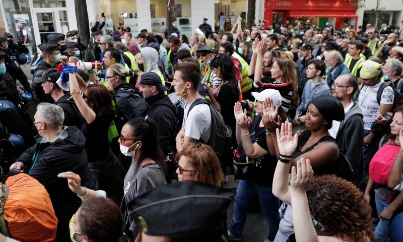 Protestors take part in a demonstration against the new coronavirus safety measures including a compulsory health pass called for by the French government, in Paris on July 17. — AFP