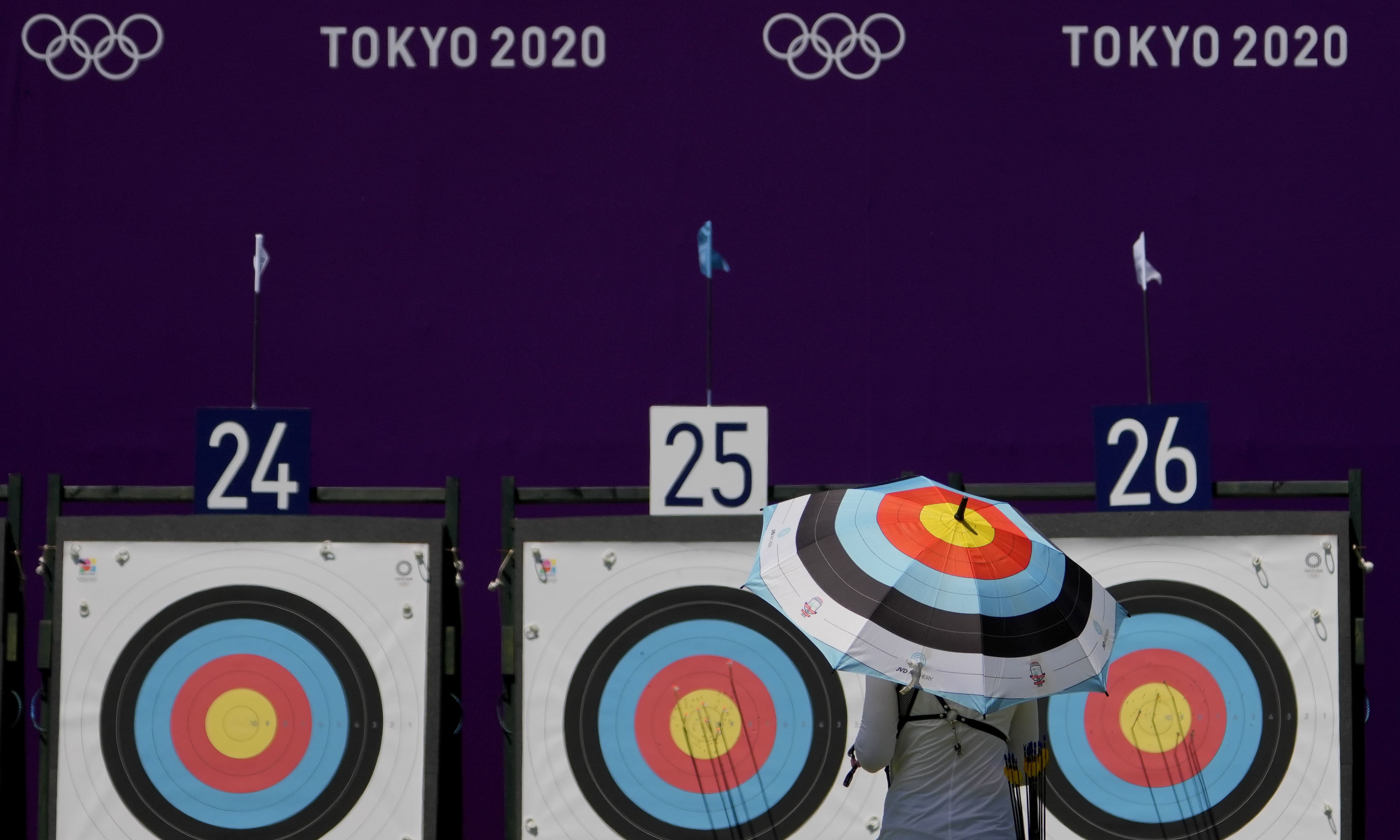 An athlete from Ukraine walks to collect her arrows as she practices for the 2020 Summer Olympics at Yumenoshima Park Archery Field, on Sunday, in Tokyo. — AP