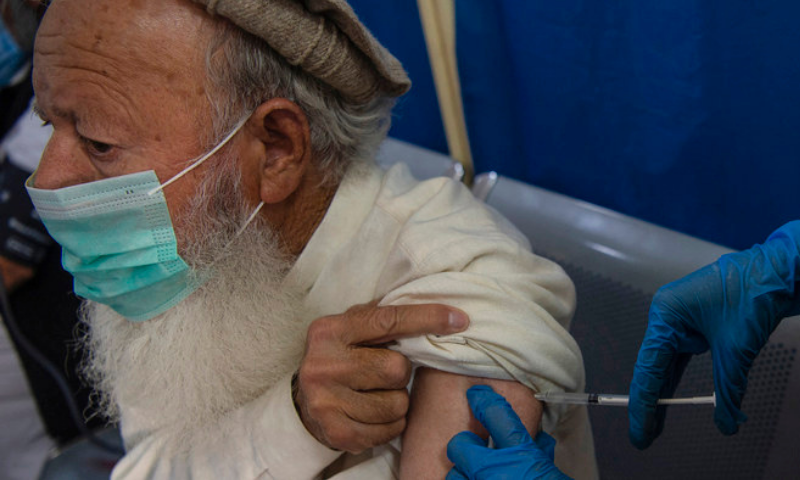 A senior citizen receives a dose of a Covid-19 vaccine at a vaccination centre in Peshawar. — AFP/File