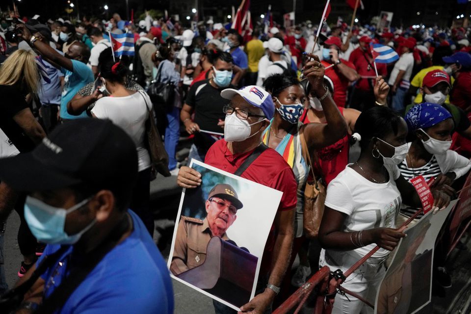 A man holds an image of Cuba's former President and First Secretary of the Communist Party Raul Castro during a rally amid concerns about the spread of the coronavirus in Havana, Cuba, July 17. &mdash; Reuters