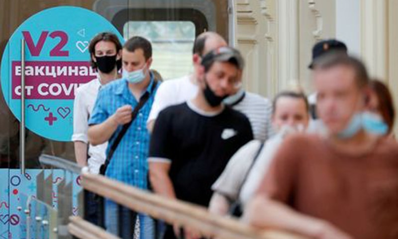 In this file photo, people line up to receive Covid-19 vaccine shots outside a vaccination centre in the State Department Store, GUM, in central Moscow, Russia. — Reuters/File