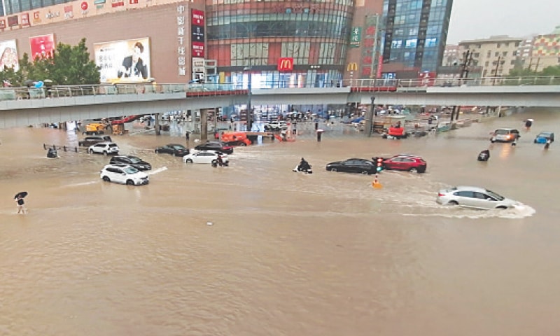 VEHICLES are stranded after a downpour in Zhengzhou on Tuesday.—AP