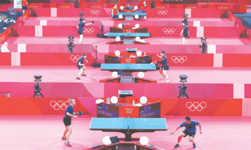 TABLE tennis players train at the Tokyo Metropolitan Gymnasium on Tuesday.—Reuters