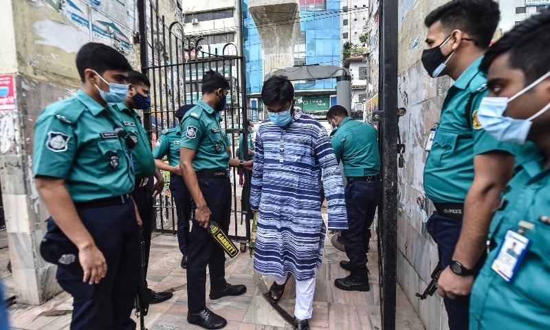 People walks through a security check post as they arrive to offer prayers to mark Eidul Azha in Dhaka on July 21. — AFP