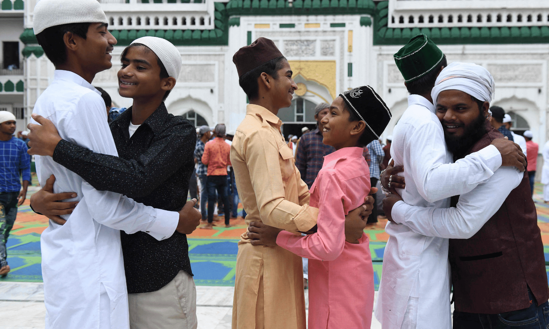 People greet each other after offering prayers during Eidul Azha or the 'Festival of Sacrifice, at Jama Masjid Khairuddin in Amritsar. — AFP