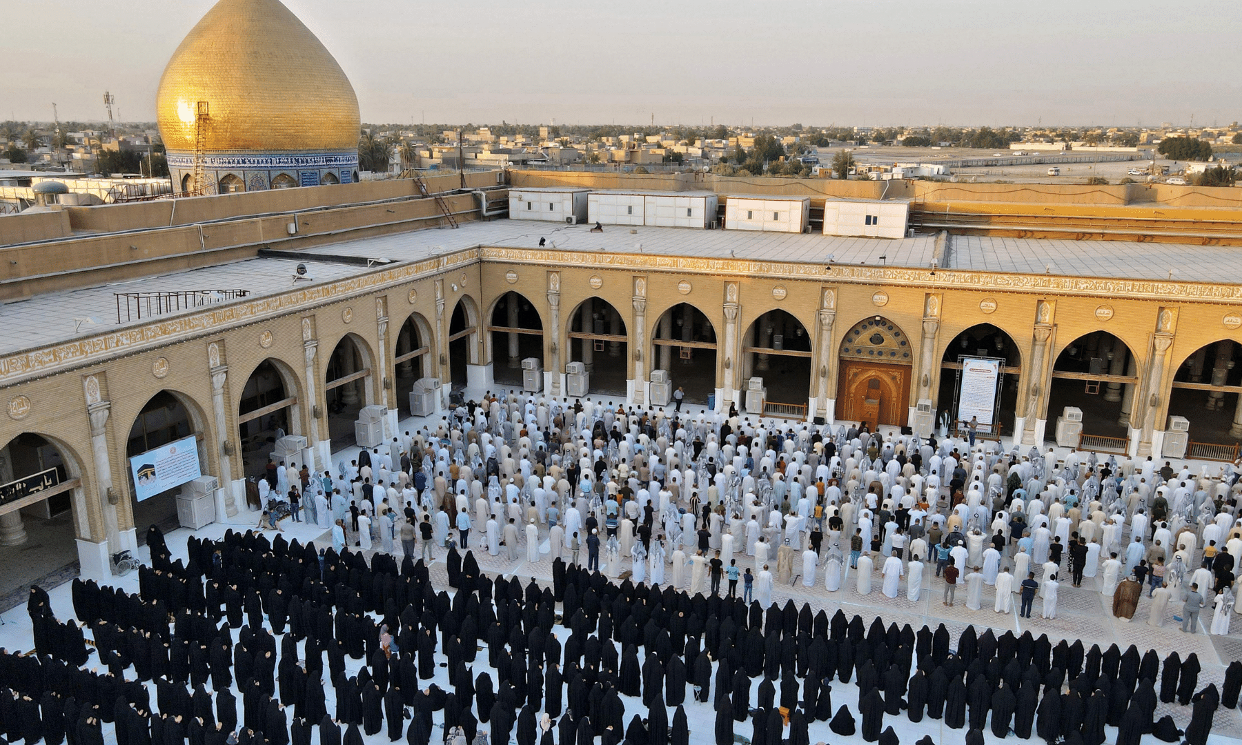 An aerial view shows Iraqis performing Eidul Azha prayer at the Great Mosque of Kufa, 10 kilometres northeast of the city of Najaf. — AFP