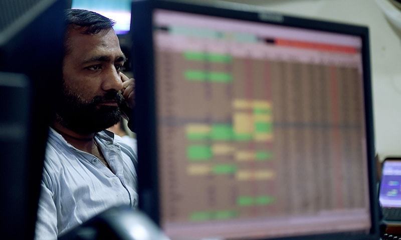 A Pakistani stockbroker looks at share prices on a computer monitor during a trading session at the Pakistan Stock Exchange (PSX) in Karachi. — AFP/File