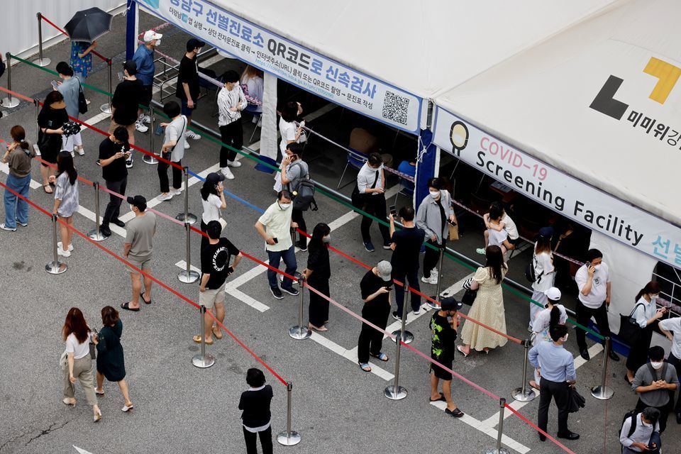People wait in line for a Covid-19 test at a testing site which is temporarily set up at a public health centre in Seoul, South Korea, July 9. — Reuters