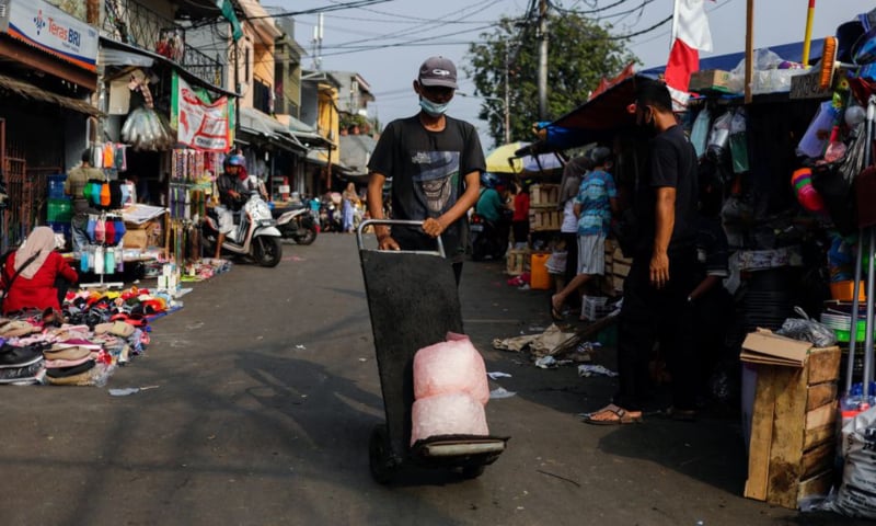 A man wearing a protective mask pushes a trolley at a traditional market amid the coronavirus outbreak, in Jakarta, Indonesia, July 24. — Reuters