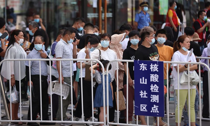In this file photo, people line up at a makeshift nucleic acid testing site outside a shopping mall in Jiangning district, China. &mdash; Reuters/File