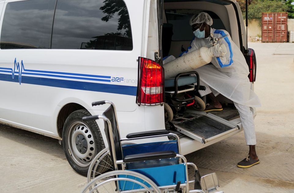 A health worker loads an oxygen cylinder into an ambulance outside the infectious diseases department of the Fann University Hospital in Dakar, amid a surge of coronavirus cases in Senegal, July 28. — Reuters