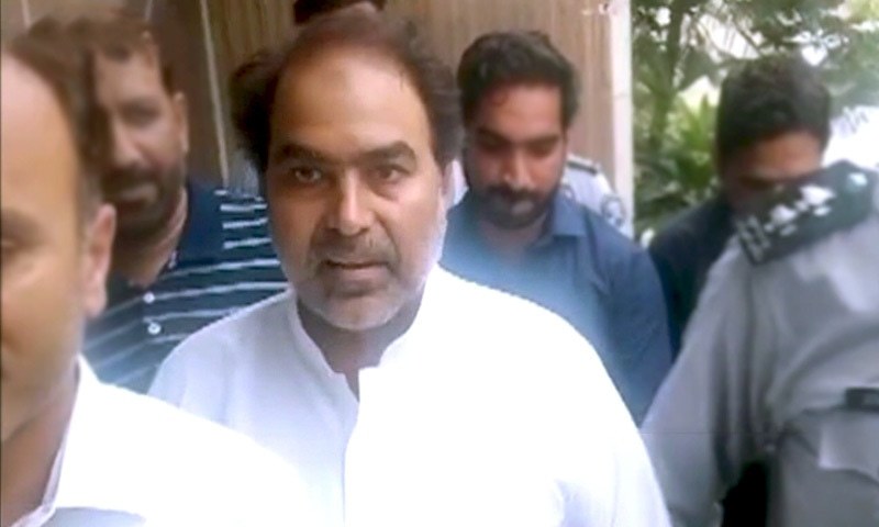 PTI MPA Nazir Chohan is led away after a district court remanded him to the Federal Investigation Agency's custody in Lahore, July 29. — DawnNewsTV