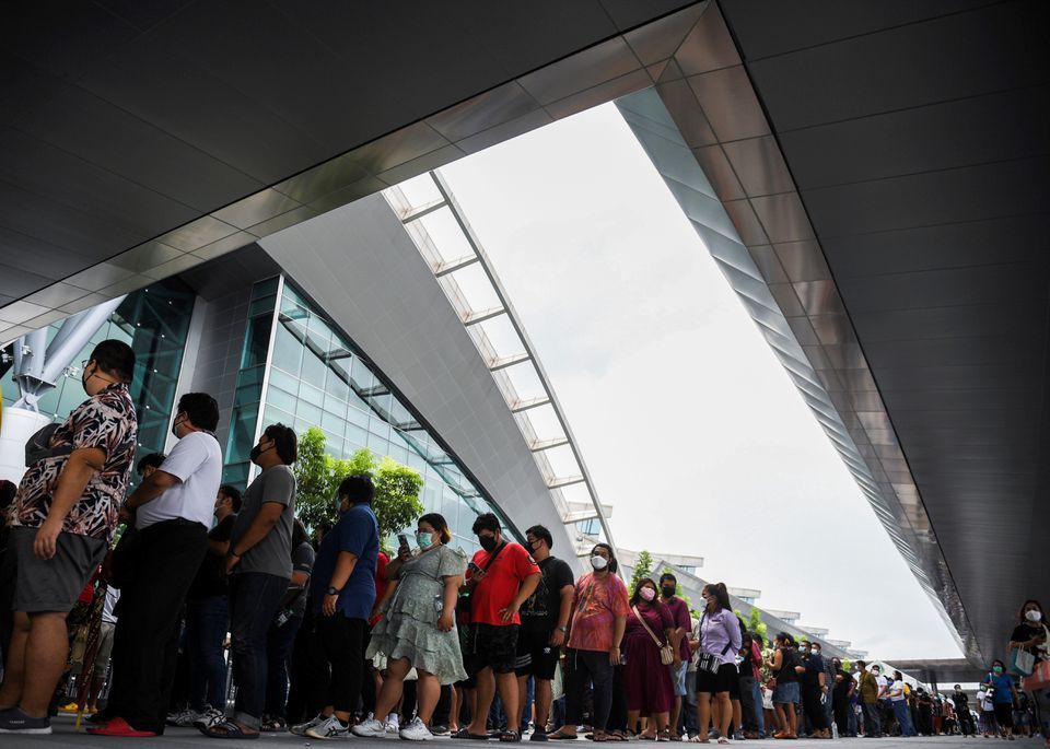 People wearing masks queue outside the Central Vaccination Centre as Thailand opens walk-in first dose of the AstraZeneca vaccination scheme in Bangkok, Thailand, July 22. — Reuters