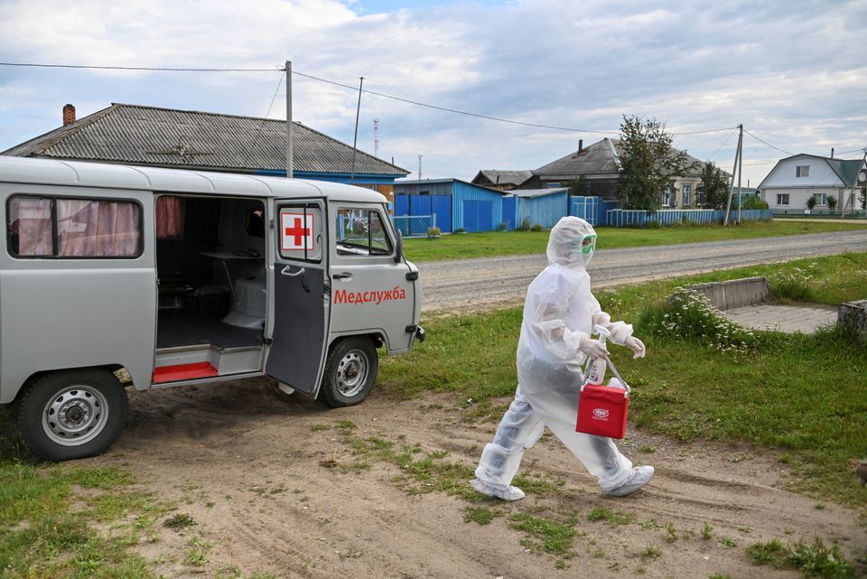 Paramedic Yulia Medvedeva wearing protective suit visits a Covid-19 patient in the village of Martyushevo, Omsk region, Russia, July 28. — Reuters