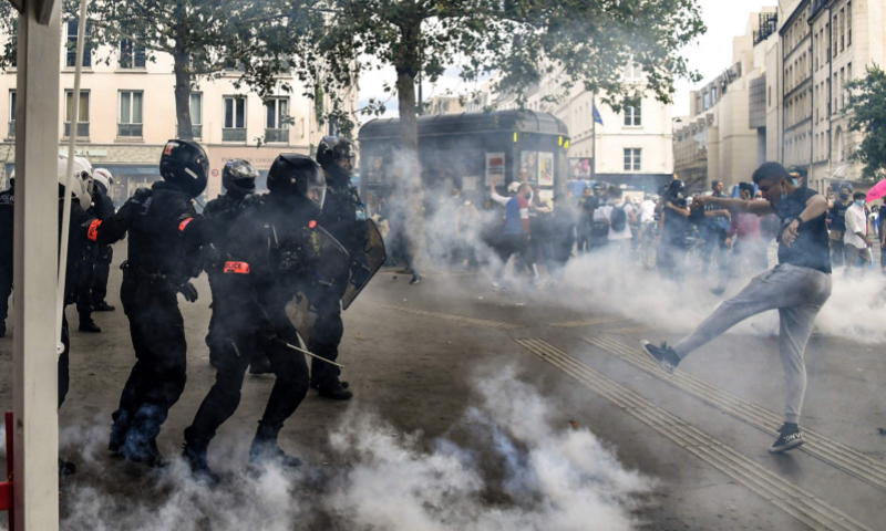 Demonstrators clash with anti-criminality (BAC) and BRAV police brigades at the end of a demonstration part of a national day of protest against French legislation making a Covid-19 health pass compulsory to visit a cafe, board a plane or travel on an inter-city train, in Paris on Saturday. &mdash; AFP