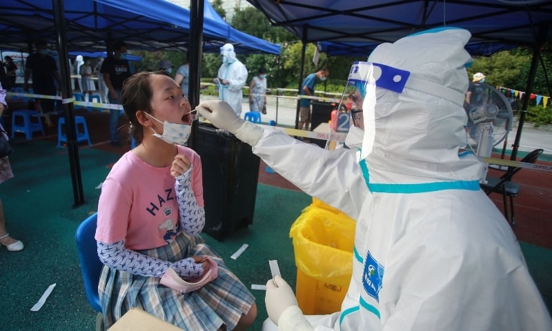 This photo taken on August 1, 2021 shows a resident receiving a nucleic acid test for the Covid-19 coronavirus in Yangzhou in China's eastern Jiangsu province. — AFP