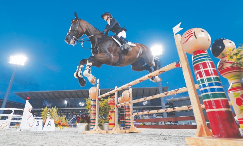 GERMANY’S Julia Krajewski, riding Amande de B’Neville, competes during the Equestrian Eventing Jumping competition on Monday.—AP