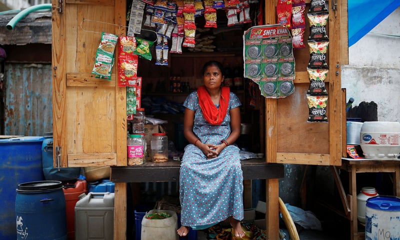 Chineya Devi, 32, who lost her job in a packaging firm, sits inside her roadside stall, near her house, in New Delhi, India. &mdash; Reuters/File