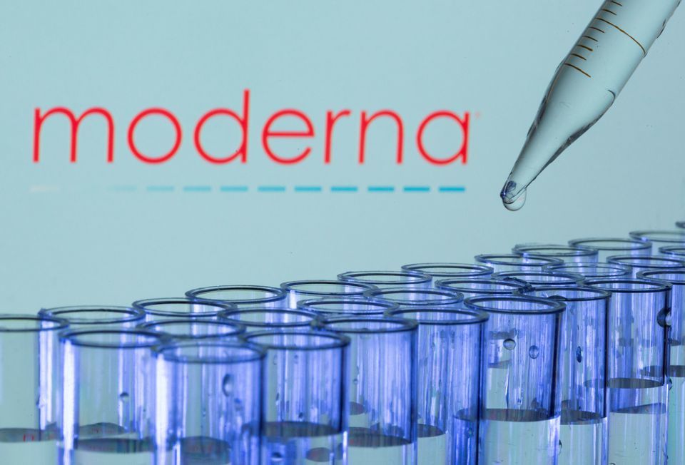 Test tubes are seen in front of a displayed Moderna logo. — Reuters/File