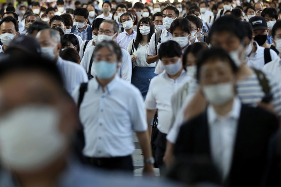 Commuters wearing face masks arrive at Shinagawa Station at the start of the working day in Tokyo, Japan, August 2. — Reuters