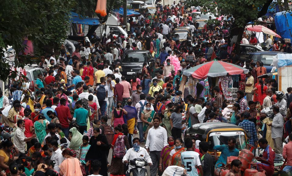 People are seen at a crowded market in Mumbai, India, July 28. — Reuters