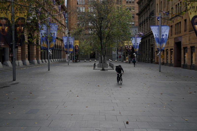 A lone cyclist rides through the empty Martin Place in the city centre during a lockdown to curb the spread of a coronavirus outbreak in Sydney on July 28. &mdash; Reuters
