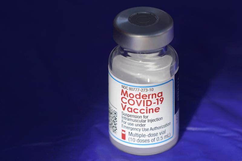 A vial of the Moderna Covid-19 vaccine rests on a table at a drive-up mass vaccination site. &mdash; AP/File