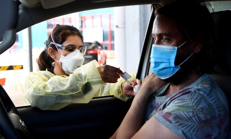 A resident receives a dose of the Pfizer Covid-19 vaccine in Australia's first drive through vaccination centre in the outer Melbourne suburb of Melton on August 10. — AFP