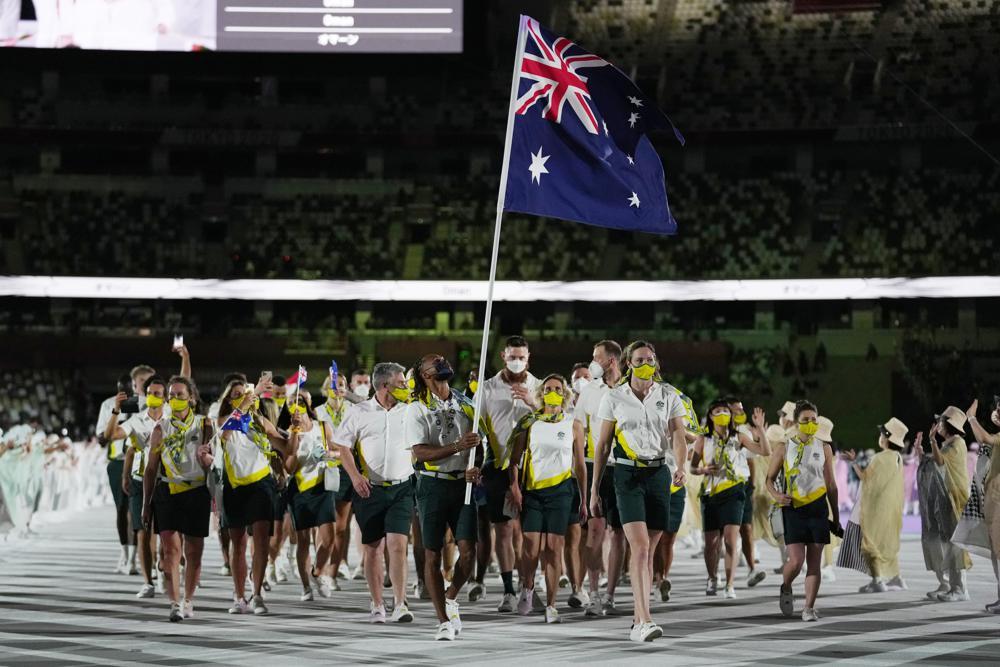 Cate Campbell and Patty Mills, of Australia, carry their country's flag during the opening ceremony in the Olympic Stadium at the 2020 Summer Olympics in Tokyo, Japan on July 23. — AP