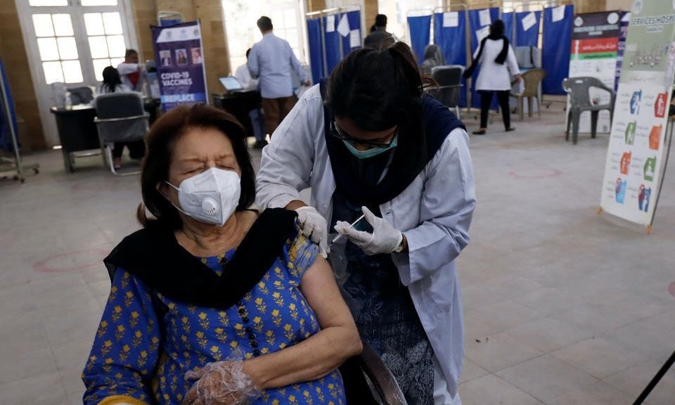 A woman receives the first dose of the coronavirus vaccine at a vaccination centre in Karachi. &mdash; Reuters/File