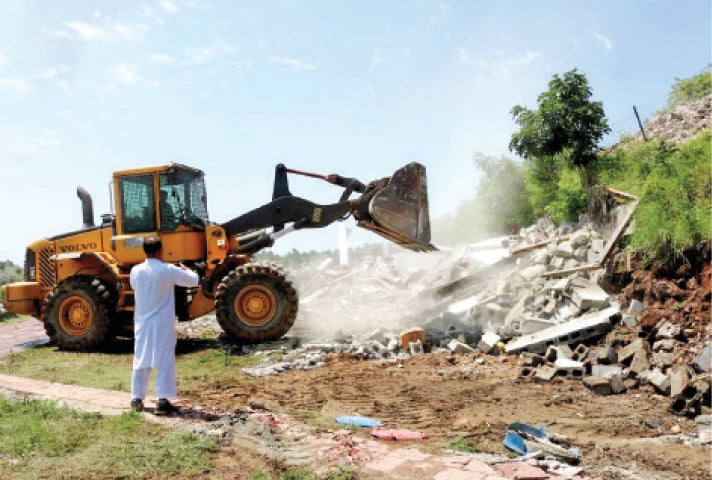 CDA demolishes structures in Talhar village on the Margalla Hills on Sunday. — White Star