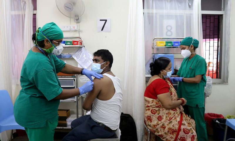 In this file photo, Rohit Gupta, 27 and Nandani Gupta, 42, receive their first dose of the Covishield vaccine at a vaccination centre in Mumbai, India. — Reuters/File