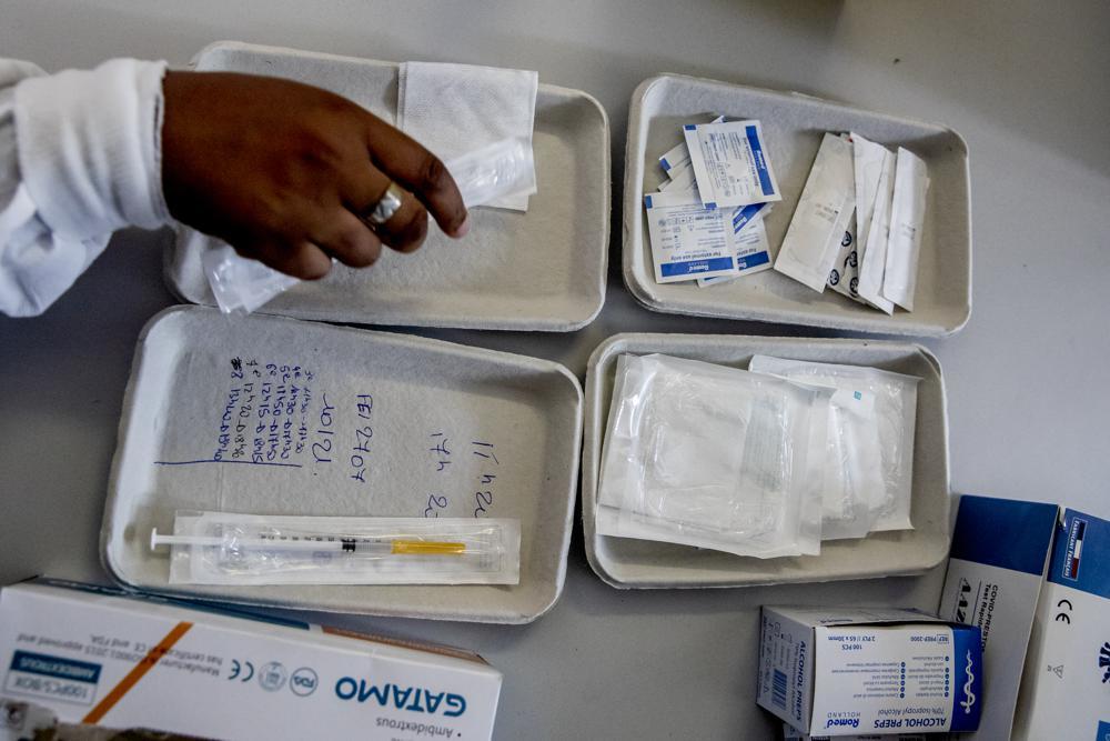 A Red Cross volunteer handles the Covid-19 vaccinations in Le Bourget, north of Paris on Aug 13. — AP