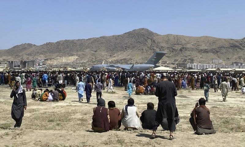 Hundreds of people gather near a US Air Force C-17 transport plane at a perimeter at the international airport in Kabul, Afghanistan on August 16. — AP/File