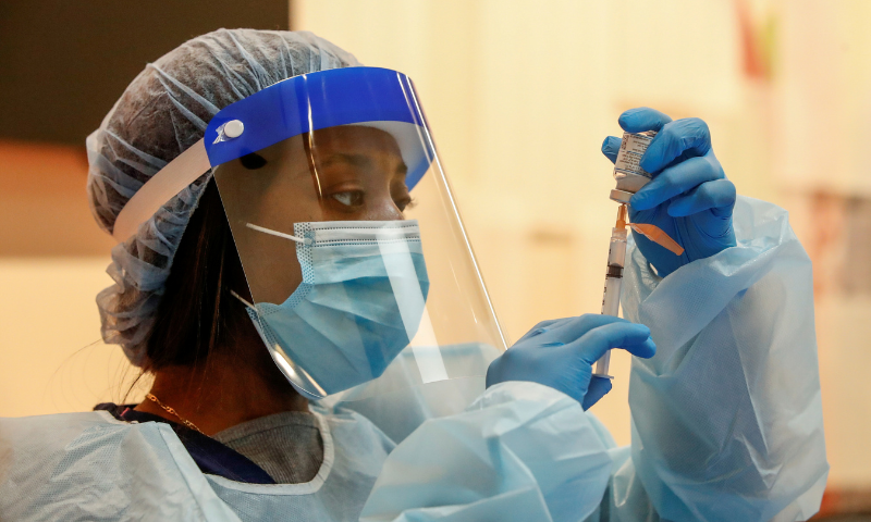 Medical assistant Mariasha Davis draws the Moderna Covid-19 vaccine into a syringe before people are inoculated at Trinity United Church of Christ in Chicago, Illinois, US. &mdash; Reuters/File