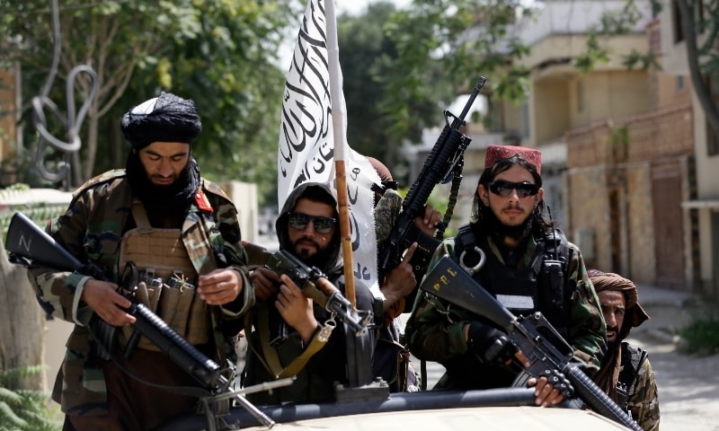 In this August 19 file photo, Taliban fighters display their flag on patrol in Kabul, Afghanistan. — AP