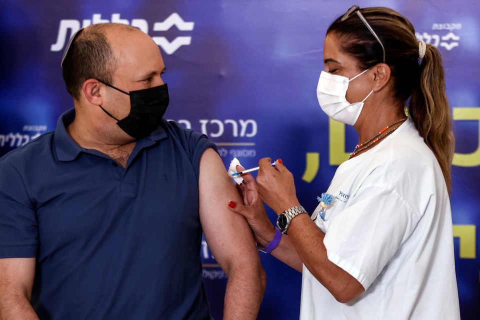 Israeli Prime Minister Naftali Bennett receives a third shot of coronavirus vaccine as Israel launches booster shots for over 40 year-olds in Kfar Saba, Israel on August 20. &mdash; Reuters