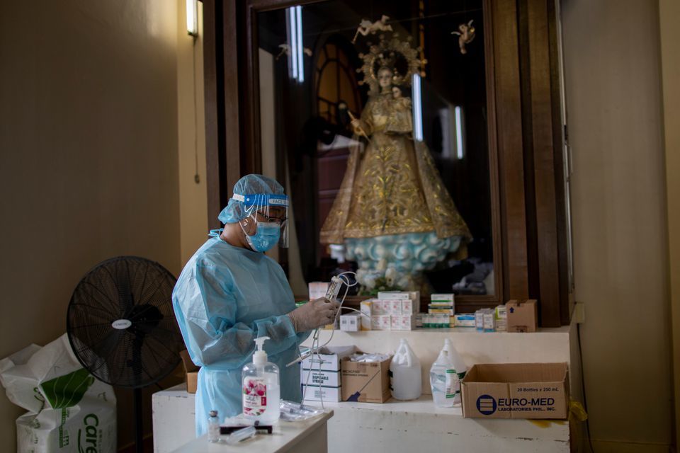 A health worker prepares Remdesivir for a coronavirus patient admitted in the chapel of Quezon City General Hospital turned into a Covid-19 ward amid rising infections, in Quezon City, Metro Manila, Philippines on August 20. — Reuters