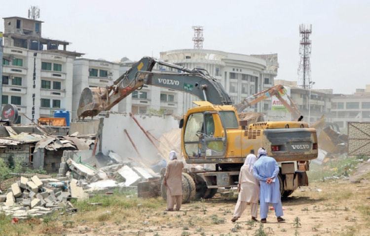 Capital Development Authority (CDA) team razes illegal structures in Islamabad. &mdash; INP/File