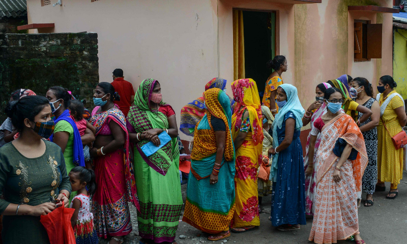 Women queue up to get themselves inoculated with a coronavirus vaccine at a free vaccination camp in Siliguri, India on Tuesday. — AFP