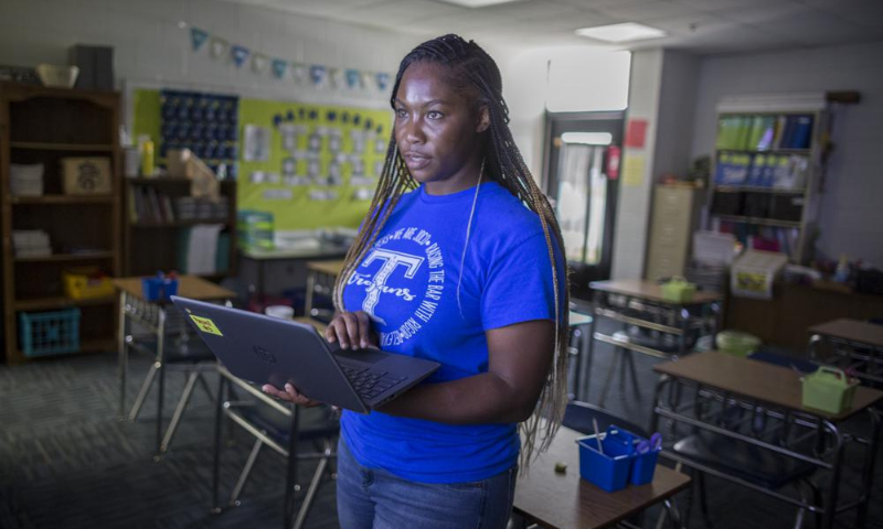 Johnson County Middle School teacher Shaunteria Russell teaches her 7th grade students math from an empty classroom. — AP