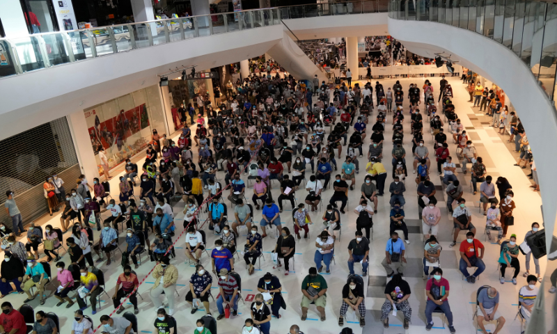 Residents wait for a dose of the Pfizer-BioNTech Covid-19 vaccine in Bangkok, Thailand, on Wednesday. &mdash; AP